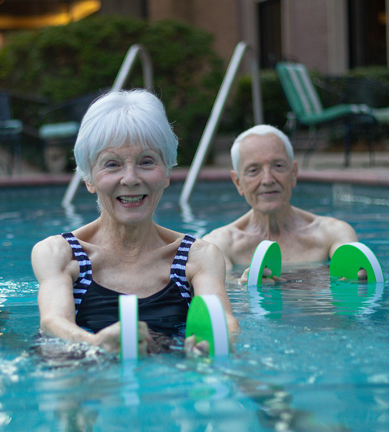 group of seniors start some exercises in the community pool at The Hallmark